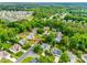 An aerial view shows a lush neighborhood with mature trees and well-maintained lawns at 1301 Cool Mist Ct, Indian Land, SC 29707