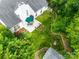 Aerial view showcasing a landscaped backyard with patio, garden, and lawn with mature trees at 1301 Cool Mist Ct, Indian Land, SC 29707
