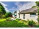 Beautifully landscaped backyard with a patio, lush lawn, and flowering plants, providing a serene outdoor space at 1301 Cool Mist Ct, Indian Land, SC 29707