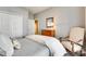 Inviting bedroom featuring an armchair, closet, and natural light from a window, perfect for relaxation at 1301 Cool Mist Ct, Indian Land, SC 29707
