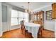 Traditional dining room with a large window, hardwood floors, and an antique china cabinet at 1301 Cool Mist Ct, Indian Land, SC 29707