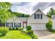 Charming two-story home featuring a well-maintained lawn, white siding, and blue shutters at 1301 Cool Mist Ct, Indian Land, SC 29707