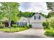 Well-manicured two-story home with blue shutters, a spacious driveway, and inviting curb appeal at 1301 Cool Mist Ct, Indian Land, SC 29707