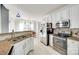 Bright kitchen featuring stainless steel appliances, tile backsplash, and white cabinetry at 1301 Cool Mist Ct, Indian Land, SC 29707
