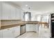 Bright kitchen featuring stainless steel appliances, tile backsplash, and white cabinetry at 1301 Cool Mist Ct, Indian Land, SC 29707