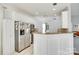 Bright kitchen featuring stainless steel appliances, breakfast bar, and white cabinetry at 1301 Cool Mist Ct, Indian Land, SC 29707