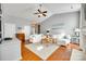 Bright living room featuring vaulted ceilings, fireplace, white couches, and hardwood floors at 1301 Cool Mist Ct, Indian Land, SC 29707