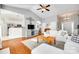 Bright living room featuring vaulted ceilings, fireplace, white couches, and hardwood floors at 1301 Cool Mist Ct, Indian Land, SC 29707