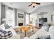Bright living room featuring vaulted ceilings, fireplace, white couches, and hardwood floors at 1301 Cool Mist Ct, Indian Land, SC 29707
