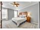 Serene main bedroom with a tray ceiling, ceiling fan and plush carpeting at 1301 Cool Mist Ct, Indian Land, SC 29707