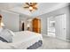 Spacious main bedroom showcasing a tray ceiling, ceiling fan, and ensuite bathroom at 1301 Cool Mist Ct, Indian Land, SC 29707