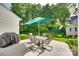 Outdoor patio with umbrella-covered table and chairs, perfect for relaxing and entertaining in a lush backyard at 1301 Cool Mist Ct, Indian Land, SC 29707
