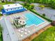 View of a community pool with a slide, tables and chairs, and building nearby at 1301 Cool Mist Ct, Indian Land, SC 29707