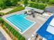 Aerial view of a community pool with a slide, lounge chairs, and well-kept surroundings at 1301 Cool Mist Ct, Indian Land, SC 29707