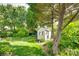 Backyard shed surrounded by mature trees and landscaping, offering extra storage space at 1301 Cool Mist Ct, Indian Land, SC 29707