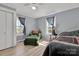 Cozy bedroom featuring light blue walls, natural light, and comfortable armchair at 1339 Hill St, Albemarle, NC 28001