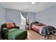 Bedroom with paneled walls, light-colored floors, a window, bed and an arm chair at 1339 Hill St, Albemarle, NC 28001