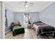 Bedroom with paneled walls, light-colored floors, a window, bed and an arm chair at 1339 Hill St, Albemarle, NC 28001