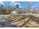Well-maintained white home with a metal roof and lush, expansive yard space at 1339 Hill St, Albemarle, NC 28001