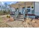 Charming front porch with steps, and gray accents, surrounded by neat landscaping at 1339 Hill St, Albemarle, NC 28001