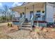 Cozy front porch with a blue door and decorative plants, set against a serene backdrop at 1339 Hill St, Albemarle, NC 28001