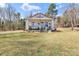 Charming white home with a covered front porch and a well-manicured lawn at 1339 Hill St, Albemarle, NC 28001