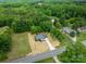 Aerial view of a charming home nestled on a spacious lot with a long driveway and mature trees at 1428 E Main St, Cherryville, NC 28021