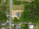 Aerial view of a cozy home with a long driveway on a spacious lot near lush green trees at 1428 E Main St, Cherryville, NC 28021