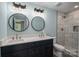 Renovated bathroom with double vanity, modern fixtures, decorative lights and tiled shower at 1428 E Main St, Cherryville, NC 28021