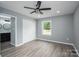 This bedroom features hardwood floors, a ceiling fan, and a view to a bathroom and closet at 1428 E Main St, Cherryville, NC 28021