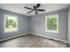 This bedroom features hardwood floors and windows overlooking a wooded lot at 1428 E Main St, Cherryville, NC 28021