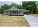 Charming single-story home with olive green siding, covered carport, and newly seeded front yard at 1428 E Main St, Cherryville, NC 28021