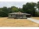 Charming single-story home with olive green siding, covered carport, and newly seeded front yard at 1428 E Main St, Cherryville, NC 28021