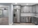 Modern kitchen featuring stainless steel appliances, gray cabinets, and granite countertops at 1428 E Main St, Cherryville, NC 28021