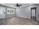 Bright living room featuring new gray wood-look flooring, gray paint, and a ceiling fan at 1428 E Main St, Cherryville, NC 28021
