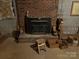 Cozy basement with a brick fireplace and wood burning stove at 1502 Shelby Hwy, Cherryville, NC 28021