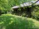 View of front exterior featuring covered porch, wood siding, and a well-maintained grassy lawn at 1502 Shelby Hwy, Cherryville, NC 28021