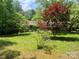 Charming home nestled in a lush, tree-filled landscape with a vibrant lawn at 1502 Shelby Hwy, Cherryville, NC 28021