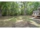 View of the expansive backyard featuring mature trees and green grass at 1513 White Ridge Dr, Rock Hill, SC 29732