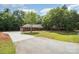 Long driveway leading up to a brick home surrounded by lush greenery and a well-maintained lawn at 1513 White Ridge Dr, Rock Hill, SC 29732