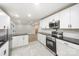 Modern kitchen showcasing white cabinets, black countertops, stainless steel appliances, and open layout at 1513 White Ridge Dr, Rock Hill, SC 29732