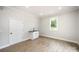 Open living room space with hardwood floors, a window, and a utility sink at 1513 White Ridge Dr, Rock Hill, SC 29732
