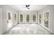 Bright sunroom with large windows offering natural light and backyard views with elegant marble floors at 1513 White Ridge Dr, Rock Hill, SC 29732