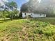 Grassy backyard featuring a single-story home and partial fencing at 16603 Nc Hwy 73 Hwy, Albemarle, NC 28001
