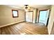 Large bedroom with a ceiling fan, white trim, and wood laminate floors at 16603 Nc Hwy 73 Hwy, Albemarle, NC 28001