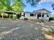 Single-story house with a gravel drive, covered front porch, and carport at 16603 Nc Hwy 73 Hwy, Albemarle, NC 28001