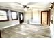 Well-lit living room with new flooring, trim, ceiling fan, and a modern gray wall color at 16603 Nc Hwy 73 Hwy, Albemarle, NC 28001