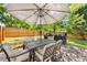 The backyard patio features an outdoor table, umbrella, and chairs on a brick surface at 1728 Privette Rd, Matthews, NC 28105