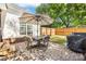 Back patio has table, umbrella, and chairs that's perfect for outdoor relaxation and entertaining at 1728 Privette Rd, Matthews, NC 28105