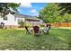 A large backyard with outdoor furniture and mature trees creating a serene atmosphere at 1728 Privette Rd, Matthews, NC 28105